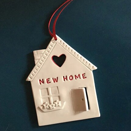 clay house ornament on navy background