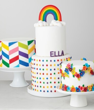 3 white cakes with rainbow fondant
