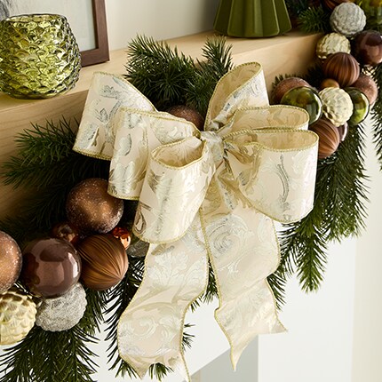 A christmas garland with ornaments and a bow