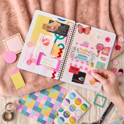 Junk Journaling with stickers and journal on a table
