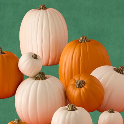 Group of orange and white pumpkins in various sizes.