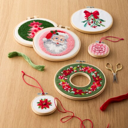 Christmas Fabric with Santa and Christmas Trees on a table with thread