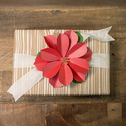 gift wrapped with poinsettia flower bow