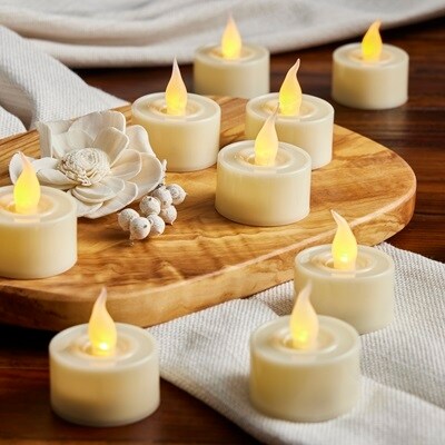 Cream LED tea lights on wooden board