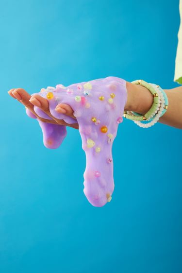 Hand holding dripping purple slime