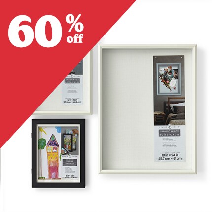 one brown wood and two white shadowbox frames