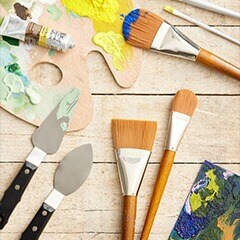 Paint brushes on wood surface