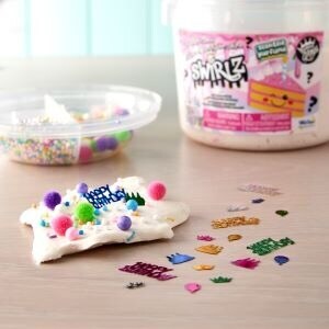 Slime kit with pieces of confetti and poms poms on top