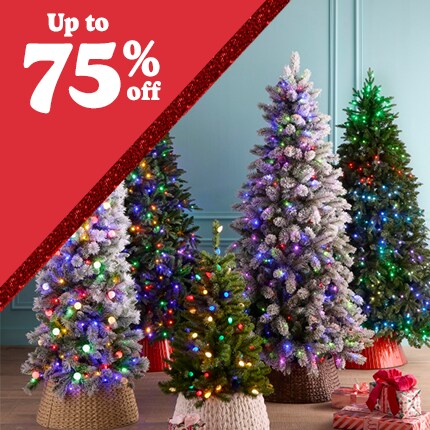 blue room with five artificial green and flocked Christmas trees with colorful lights with up to 75% off in white text in red triangle