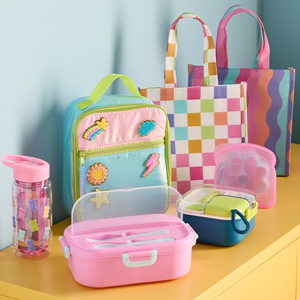 assorted pastel colored lunch boxes and bento boxes