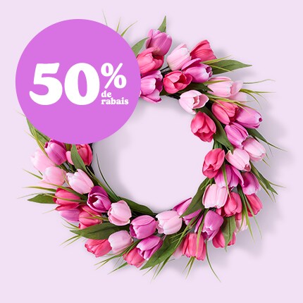 Easter wreath with floral and eggs and egg garland on a mantle 