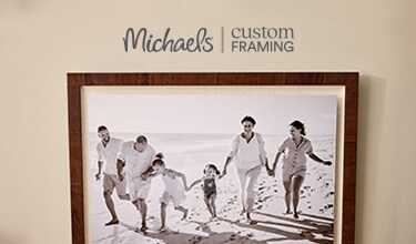 A group of vacation frames hanging on a wall.