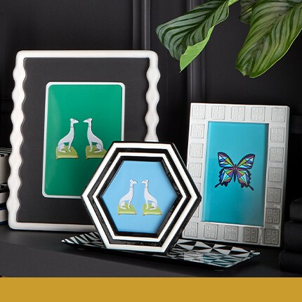 three black and white Jonathan Adler table frames