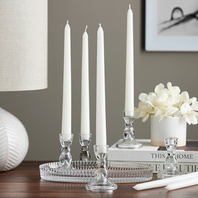 4 white tapers in glass holders white background