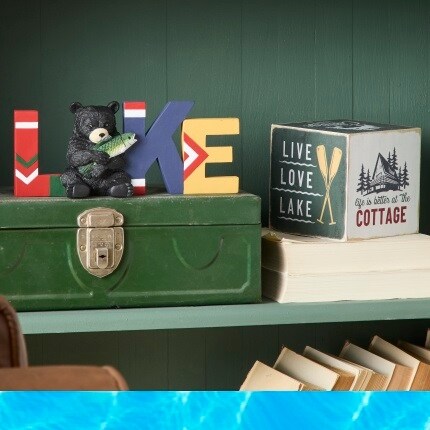 lake décor accents on green shelves
