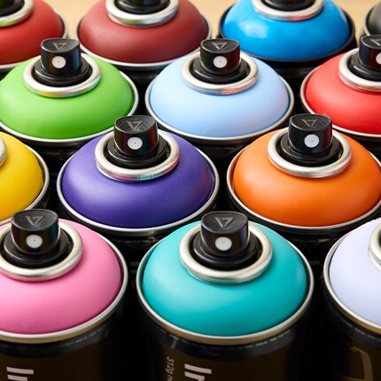tops of spray paint cans in bright colors