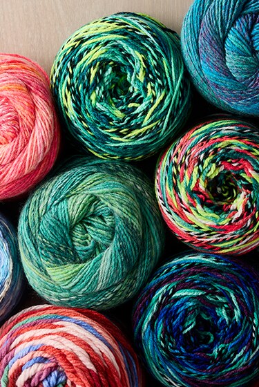 assorted yarn skeins in greens and blues