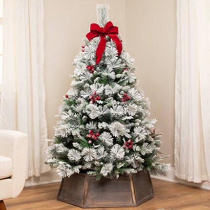 A Christmas tree with lights and red bow