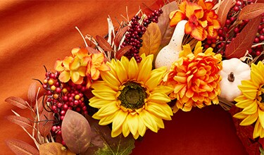 red, brown and sunflower wreath with orange background