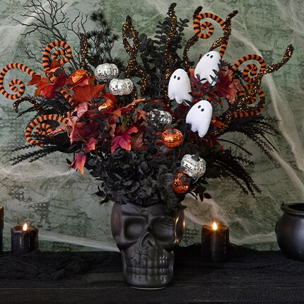 Halloween Picks in a black skull vase. Orange and black picks, Picks with Pumpkins and Picks with ghosts.