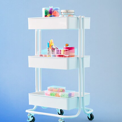 white rolling cart with blue background