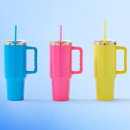 blue, pink and yellow tumblers on blue background