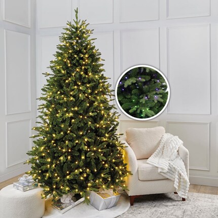A Christmas tree with lights in a room 