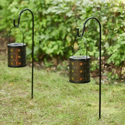 two black standing lanterns in backyard