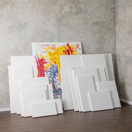 assorted size canvas leaning on gray wall