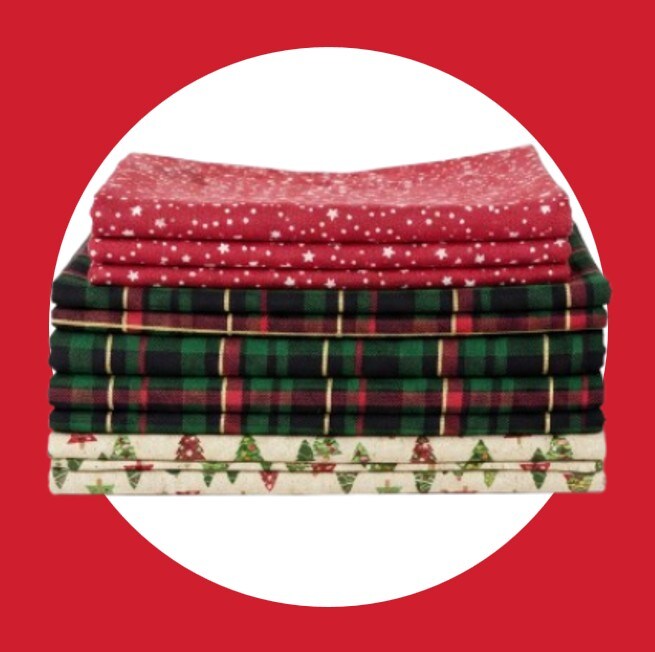 stack of christmas and holiday themed fabric