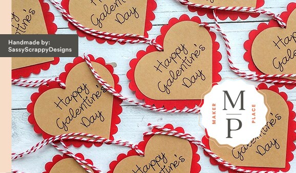 MakerPlace by Michaels Heart-shaped Galentine's Day cards with red scalloped edges, tied with red-and-white twine on a white background. Text overlay reads "Handmade by SassyScrappyDesigns."