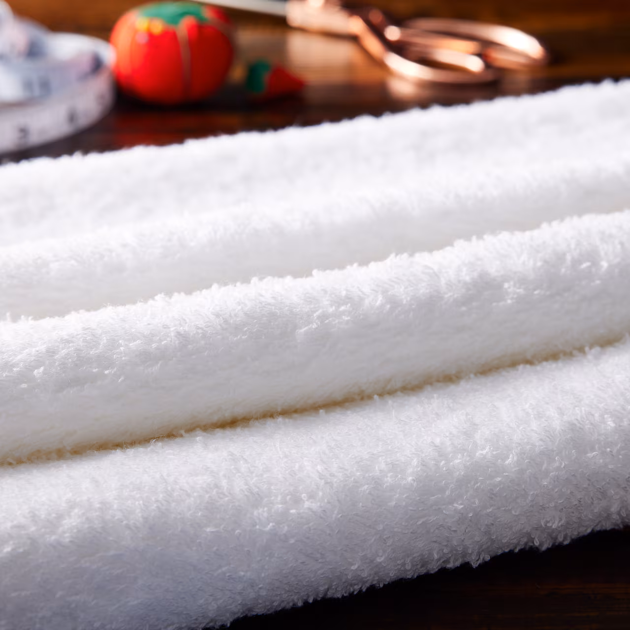 cotton polyester blend white fabric, folded on a table