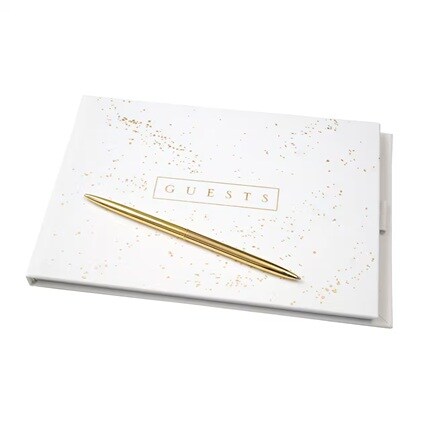 whit guest book with "Guests" in gold text on front