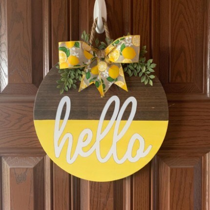 MakerPlace by Michaels Round sign with "Hello" text; brown top, yellow bottom. 
