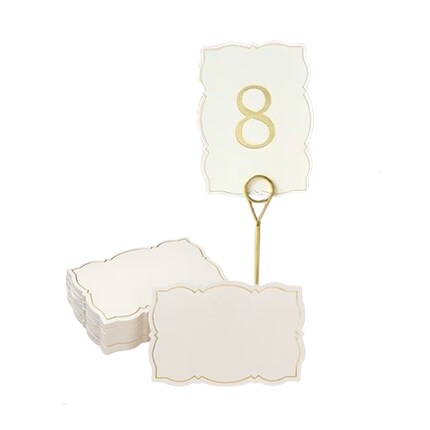 gold table number stand with a cream card with an 8 in gold and blank cards