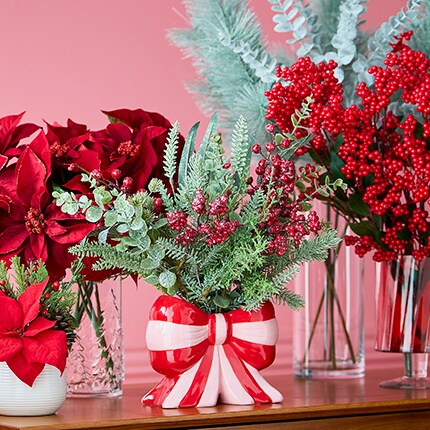 A group of red flowers in vases