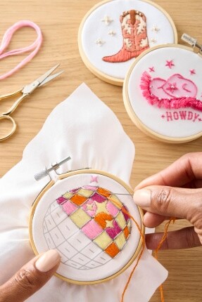 handing embroidering images of western themes