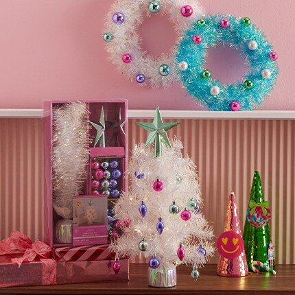 White and turquoise, white tree with multi color ornaments. 