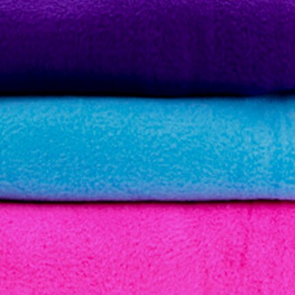 navy, blue and bright pink fleece fabrics in folded stack