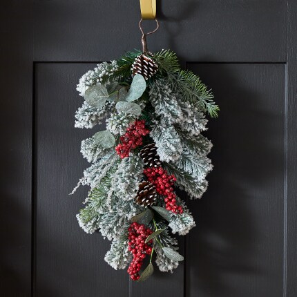 A christmas swag hanging on a door