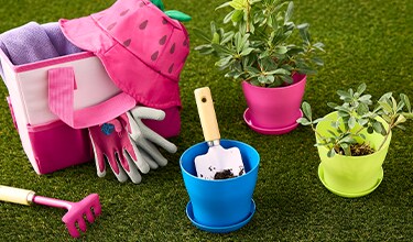 Gardening tools like a tote, bucket hat, 3 planters, gardening gloves, shovel, handheld rake. 