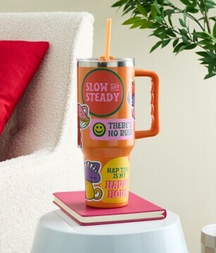 Orange tumbler with stickers