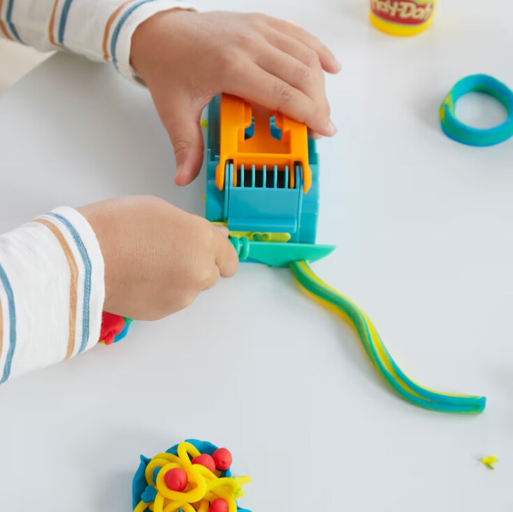 Child creating with Play doh 
