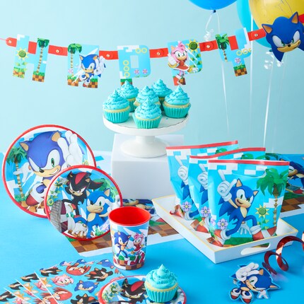 Sonic the Hedgehog party supplies with birthday banner, plates, napkins, and cups. 
