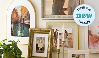assorted frames on tan wall
