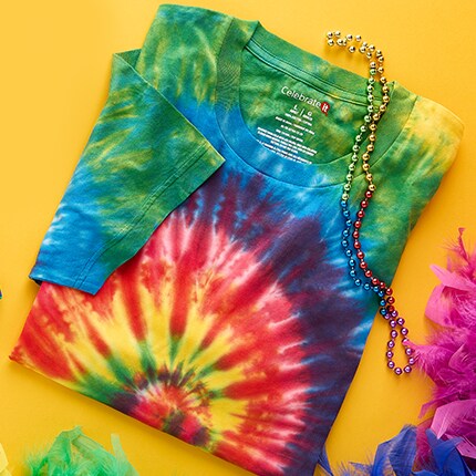 Tie-dye t-shirt featuring a spiral pattern with vibrant colors including red, yellow, blue, and green, placed on a yellow background.