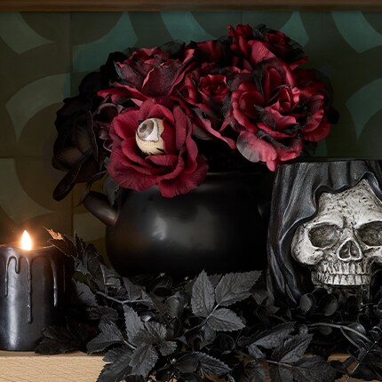 Halloween Floral Arrangement. Burgundy roses arrangement in a black pot.