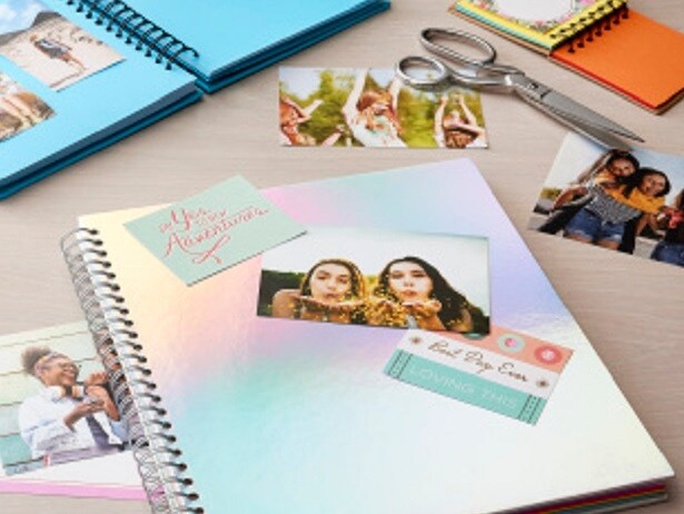 open scrapbook with photographs and scissors