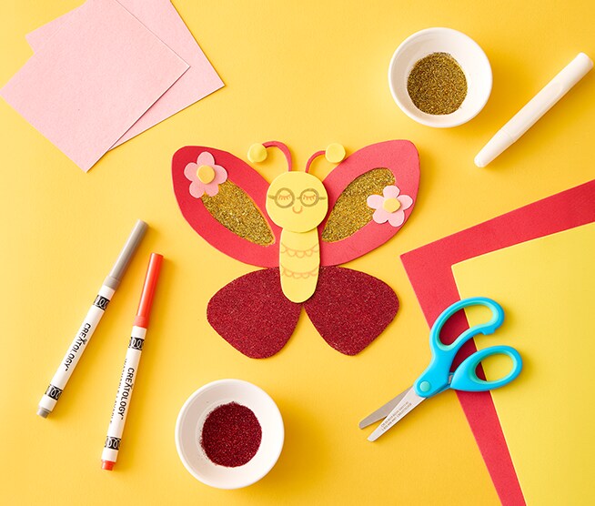 Image of a pink, red, and yellow paper butterfly