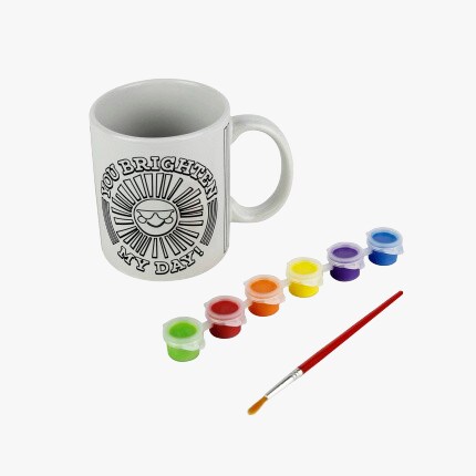 mug with paints and red brush